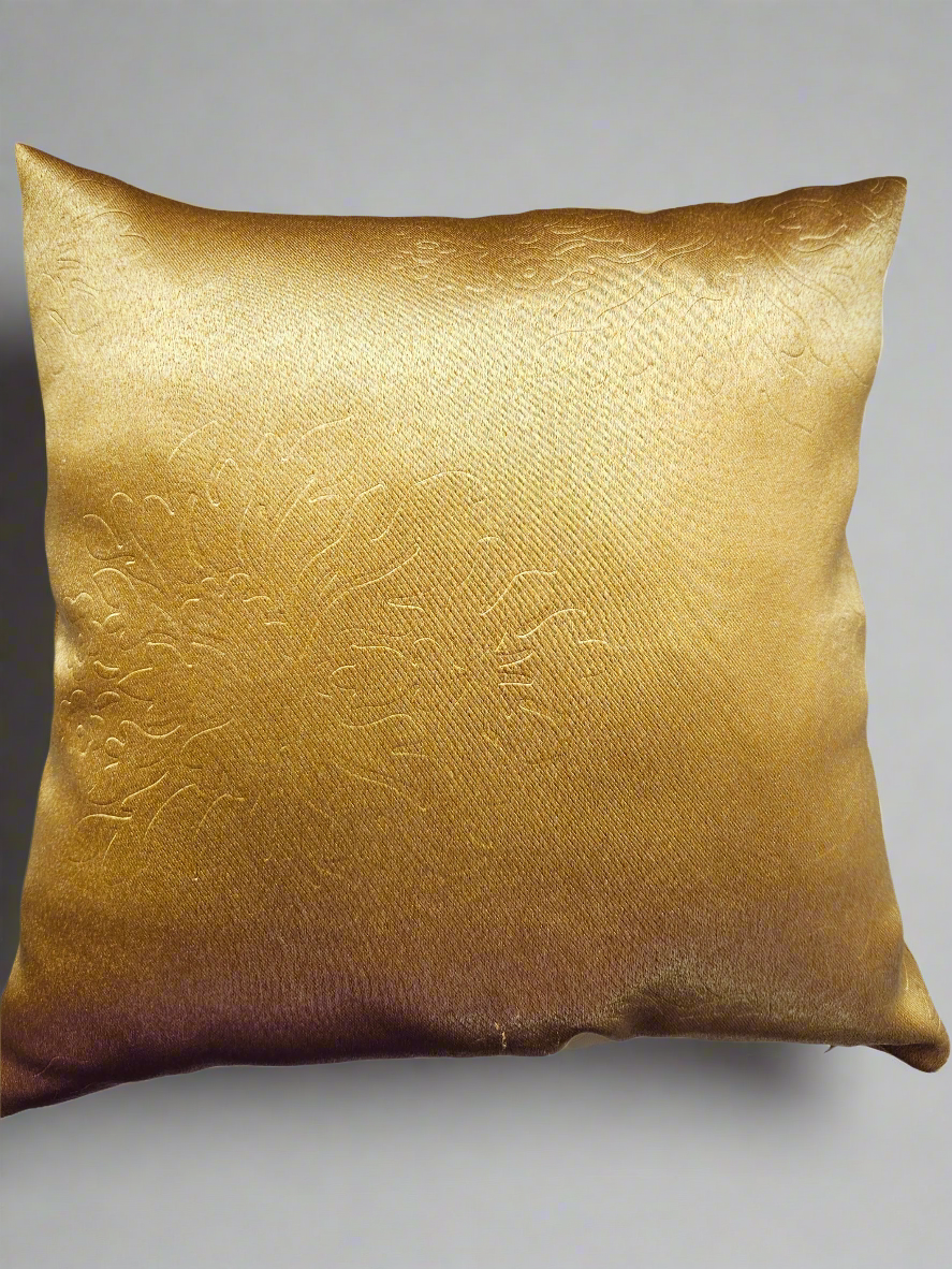 Gold textured pillow on a gray background
