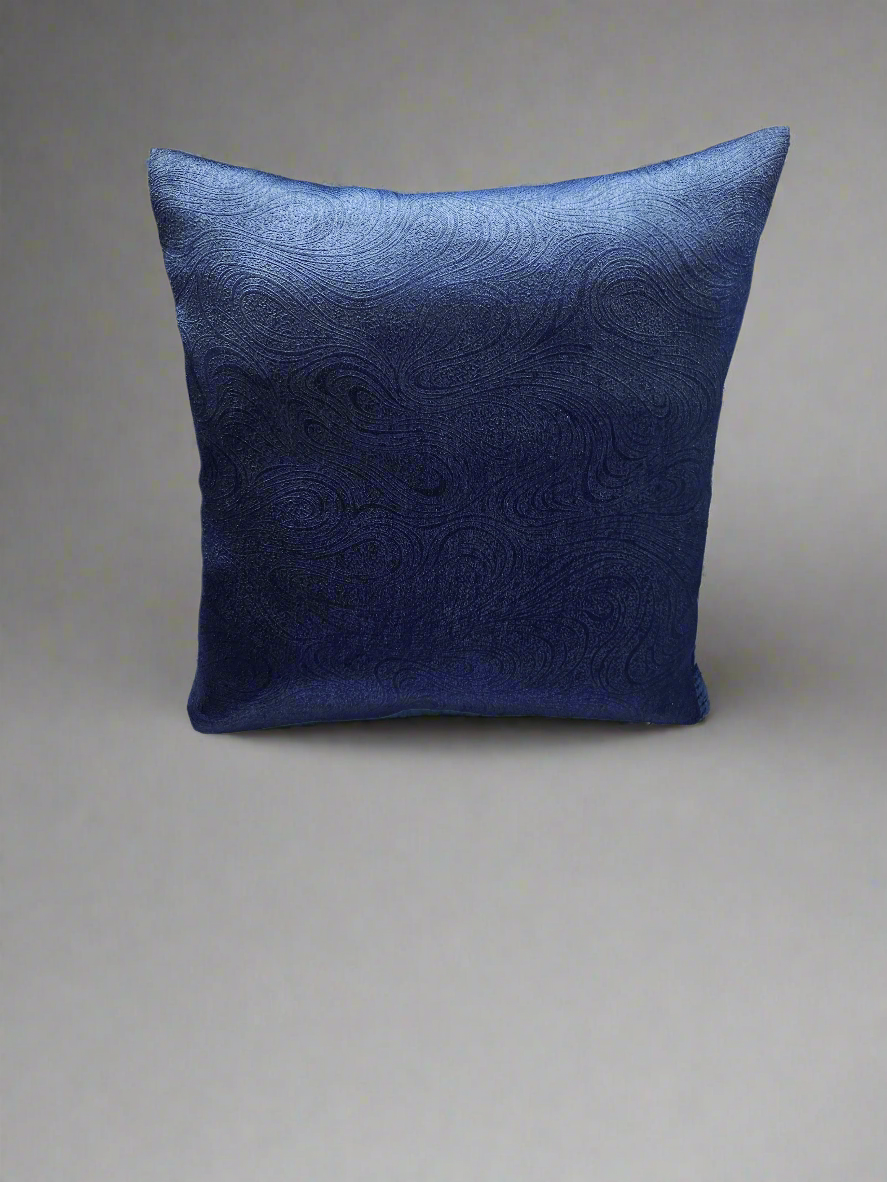 Blue decorative pillow with a subtle pattern on a white background
